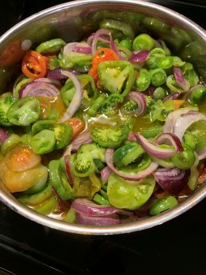 large pot filled ith green tomato and onion